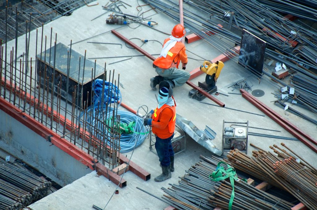 Worker safety boots on steel grating at industrial site
