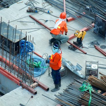 Worker safety boots on steel grating at industrial site