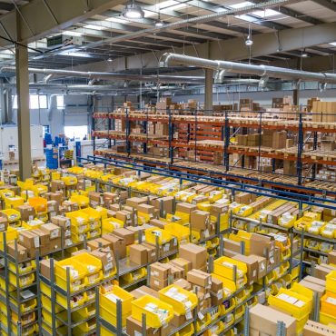 Warehouse worker wearing full PPE including safety boots